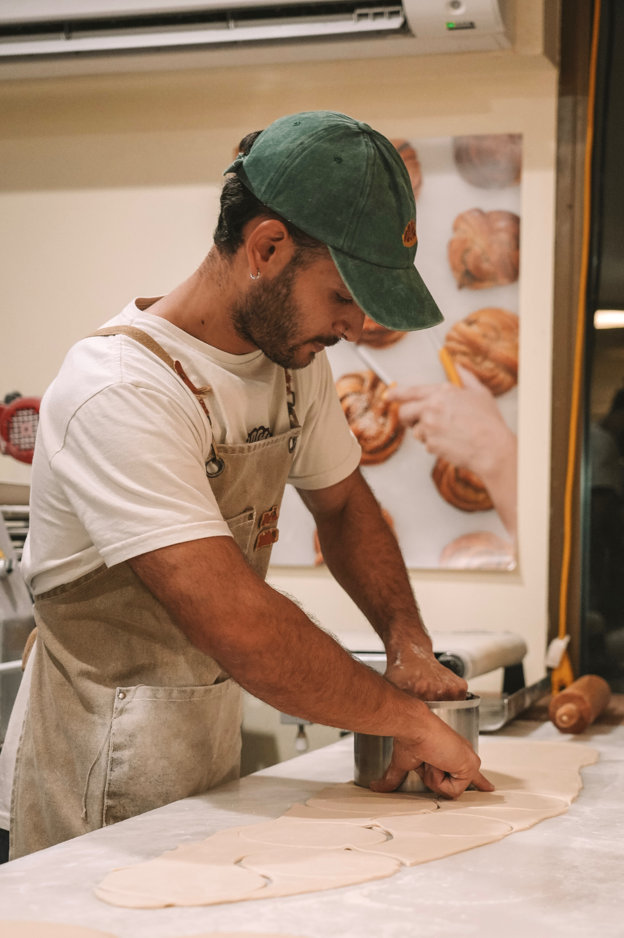 Mariano cutting fresh empanada dough in the Pocha kitchen